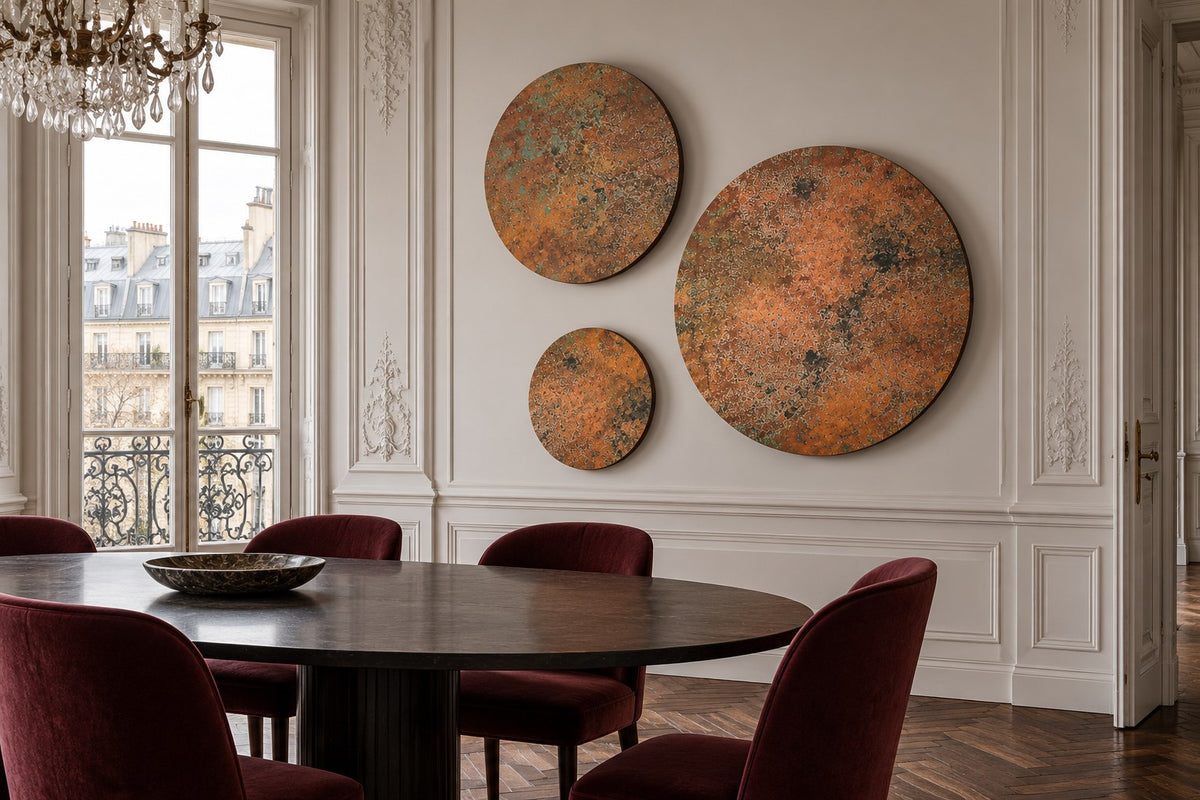 Copper Orbit Mystic Copper Nebula – 3 round copper panels on a moulded wall in a Parisian apartment dining room with burgundy velvet chairs, room visualization